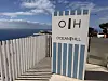 Skilt med teksten Ocean Hill ved et hotellområde med havutsikt.